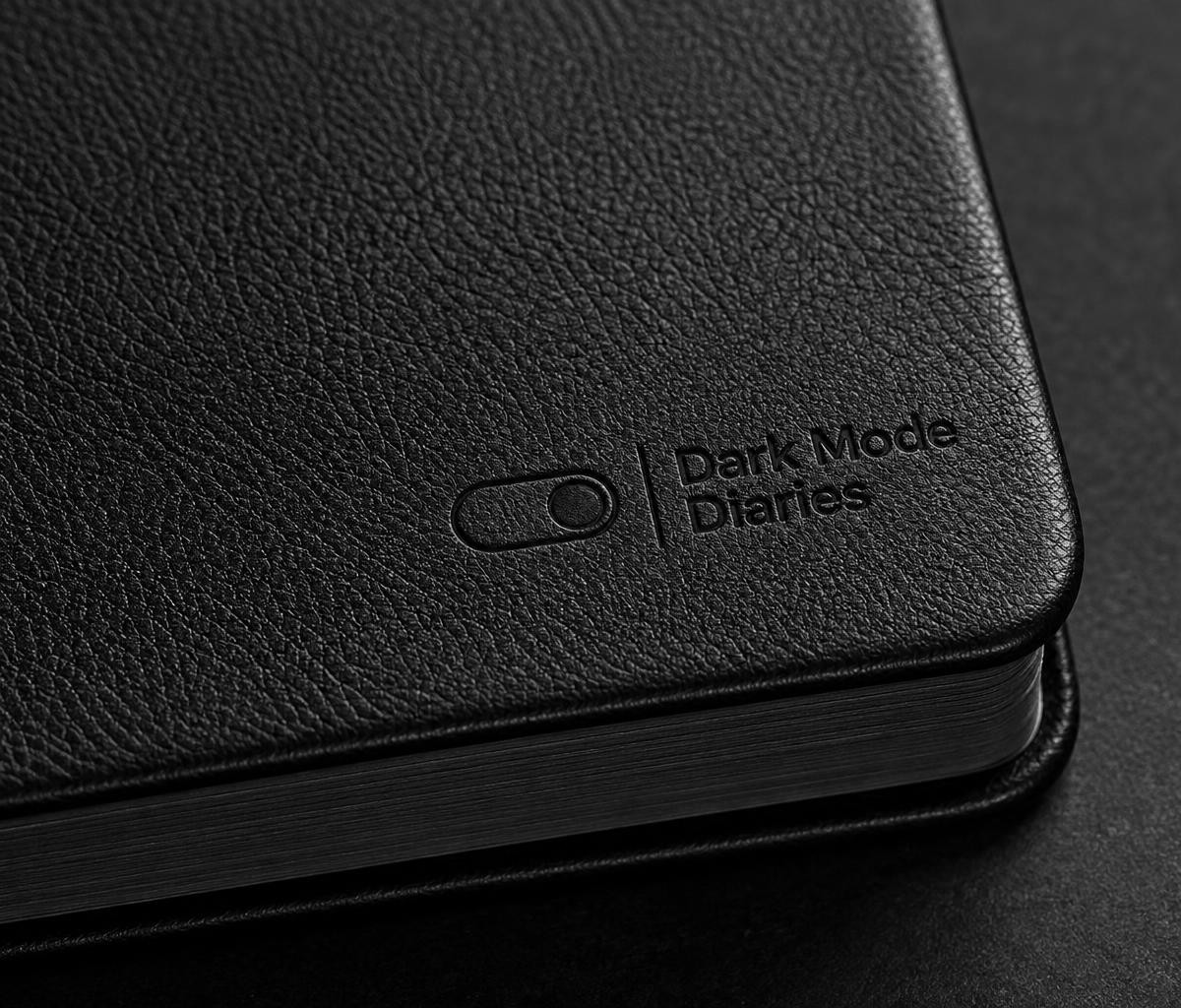 Close-up of subtly debossed Dark Mode Diaries logo, faux-leather texture, rounded corner and dark page edges.